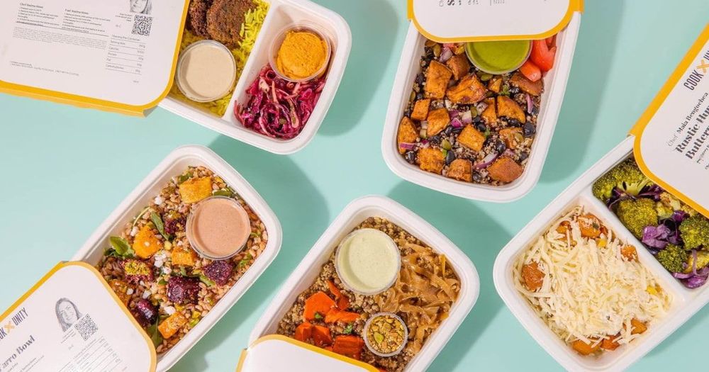 Six CookUnity chef-prepared medically tailored meals in white containers displayed on a light blue background