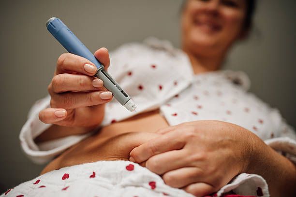 Older adult self-administering a GLP-1 injectable weight-loss medication such as Wegovy or Zepbound